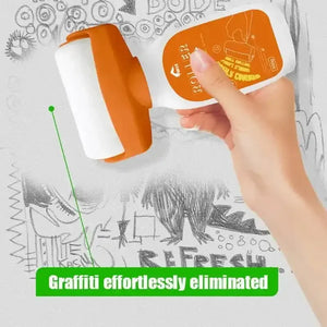 Hand using orange wall cleaning roller to remove pencil graffiti from white wall