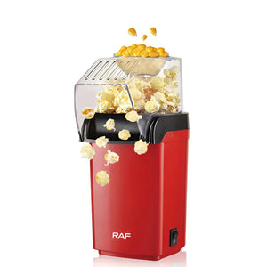 Red RAF popcorn maker with popcorn popping and kernels on top, white background.