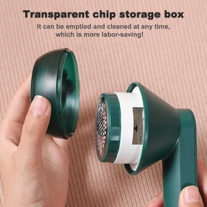 Handheld fabric shaver with removable transparent chip storage box, green color.