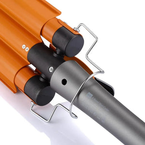 Close-up of triple barrel orange hair curler with metal stand on white background