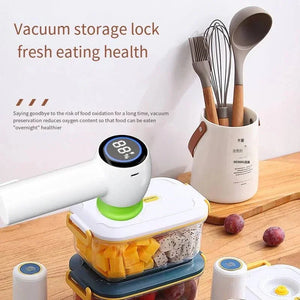 Vacuum food storage device sealing plastic containers with fruit, kitchen utensils in background