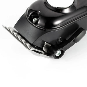 Close-up of black electric hair clipper blade on white background