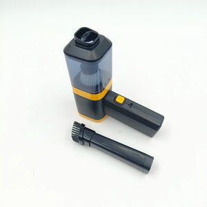 Handheld mini vacuum cleaner with brush attachment on white background