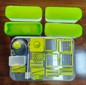 Vegetable chopper set with green containers and multiple slicer blades on a wooden table