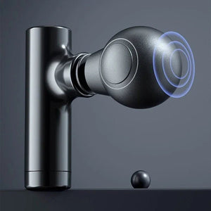Black handheld massage gun with round head on a gray background, modern wellness device