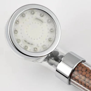 Filtered shower head with mineral beads and chrome finish on white background
