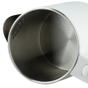 Stainless steel interior of an electric kettle with strainer holes and white exterior