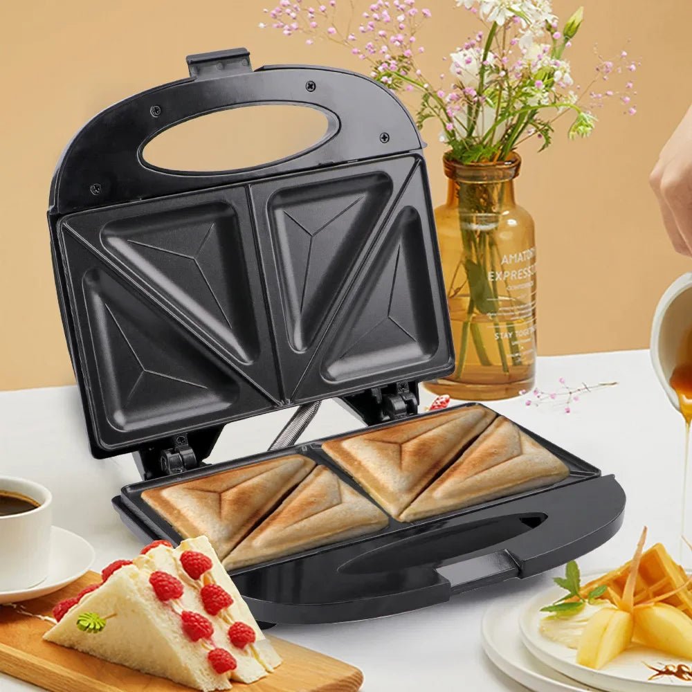 Electric sandwich maker with toasted sandwiches on a breakfast table with coffee and flowers