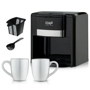 Black RAF coffee maker with two white mugs, filter basket, and measuring scoop