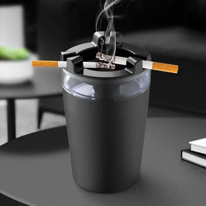 Black smokeless ashtray with cigarettes on a modern table indoors