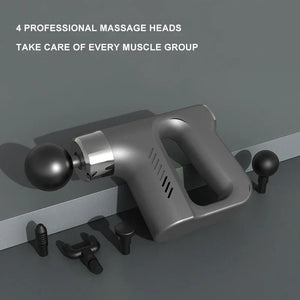 Massage gun with 4 professional heads for muscle relief on gray background