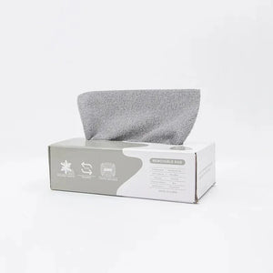Gray microfiber cleaning cloth dispensed from a white removable rag box