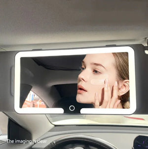 LED car vanity mirror with light, woman applying makeup in automotive interior.