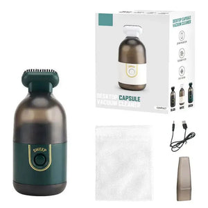 Desktop capsule vacuum cleaner kit, including device, packaging, USB cable, nozzle, and filter.