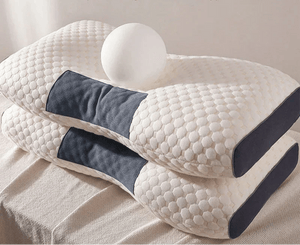 Two ergonomic memory foam pillows with honeycomb texture and dark gray panels stacked on a bed