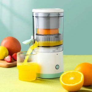 Electric citrus juicer pouring fresh orange juice into glass with fruits on table