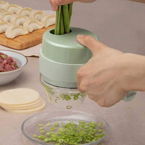 Hand using handheld rechargeable chopper to slice green beans, dumplings and ingredients nearby
