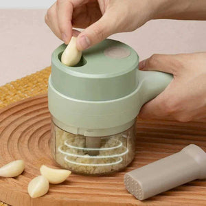 Handheld rechargeable chopper mincing garlic on wooden board, kitchen appliance