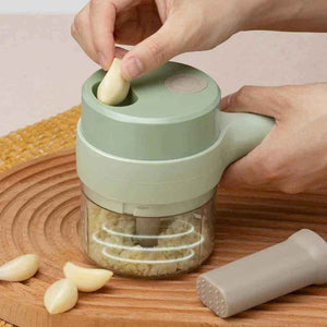 Handheld rechargeable chopper mincing garlic on wooden board, kitchen appliance