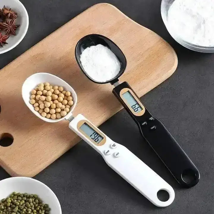 Digital measuring spoon scales with ingredients on cutting board in kitchen setting