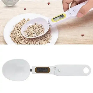 Digital measuring spoon scale weighing grains on a kitchen table, LCD display visible