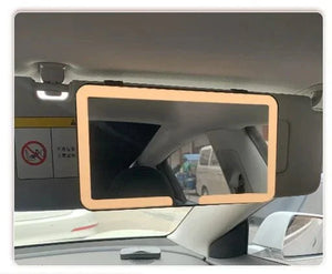 Car sun visor vanity mirror with LED light frame installed inside vehicle