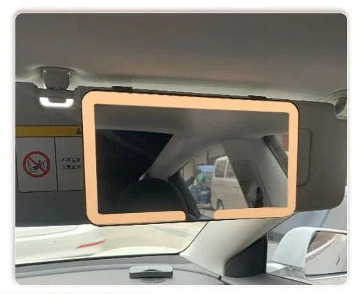 Car sun visor vanity mirror with LED light frame installed inside vehicle