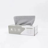 Gray microfiber cleaning cloth dispensed from a white removable rag box