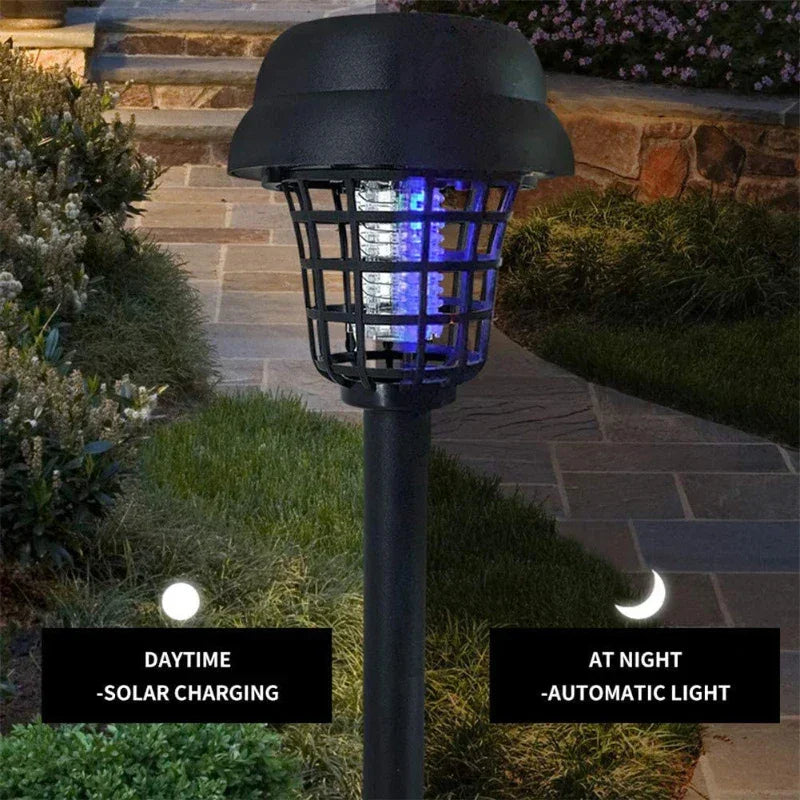Outdoor solar-powered bug zapper garden light on stone pathway at night, automatic lighting