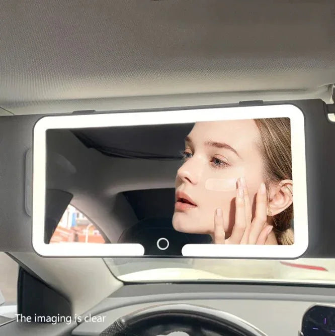 LED car vanity mirror with light, woman applying makeup in automotive interior.