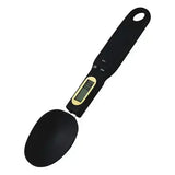 Black digital spoon scale with LCD display and control buttons on handle